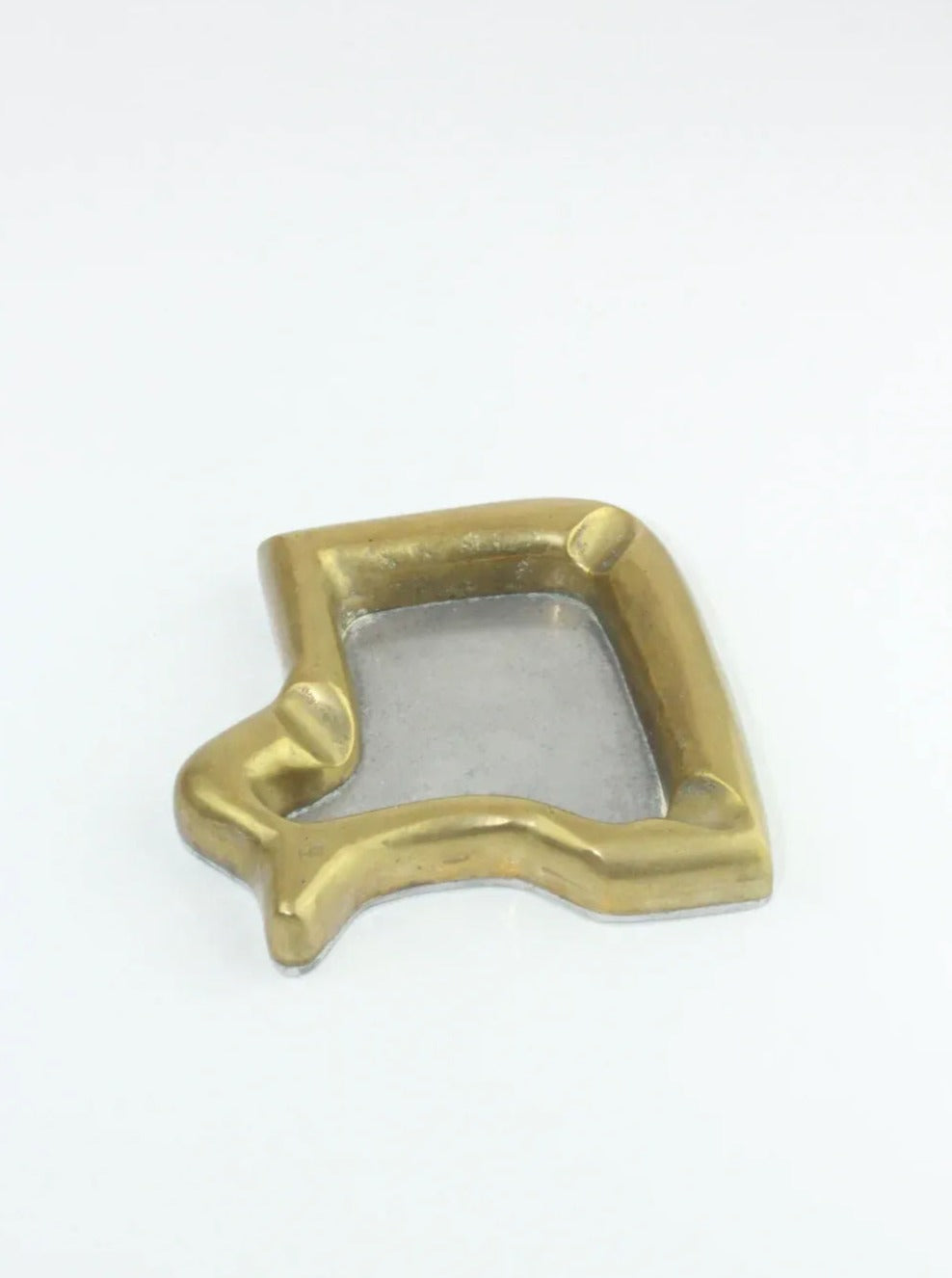 A golden bell-shaped Brutalist Ashtray with a metallic silver inner section, reminiscent of David Marshall's design aesthetic. The ashtray is placed against a plain white background, sold by Boga Avante Shop.
