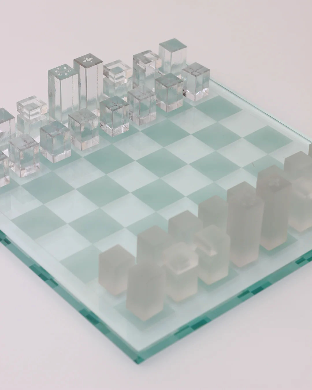 Elegant crystal chess set with frosted glass pieces on translucent board