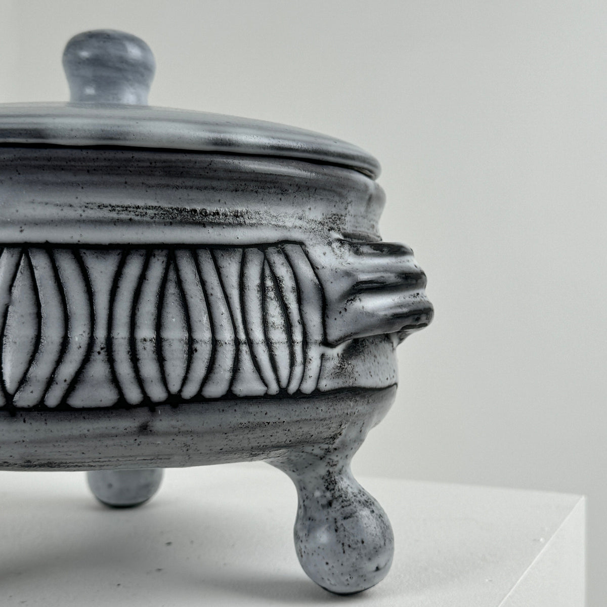 Close-up detail of ceramic tureen with carved decorative pattern
