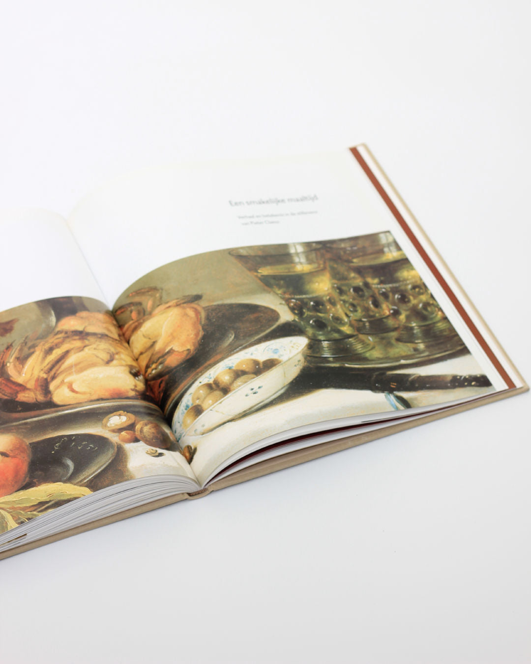 Open Pieter Claesz art book showing detailed still life paintings