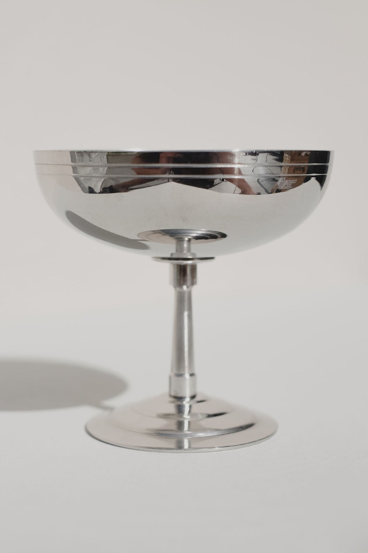 Polished steel ice coupe with reflective bowl and elegant stem