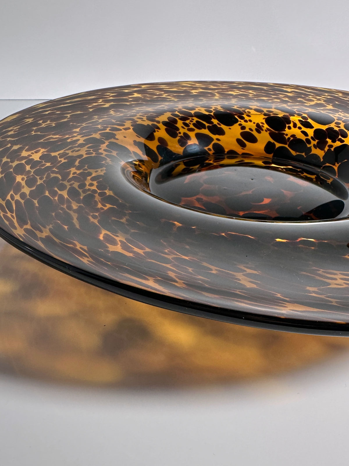 Large Murano tortoise glass fruit bowl showing curved form and spotted pattern
