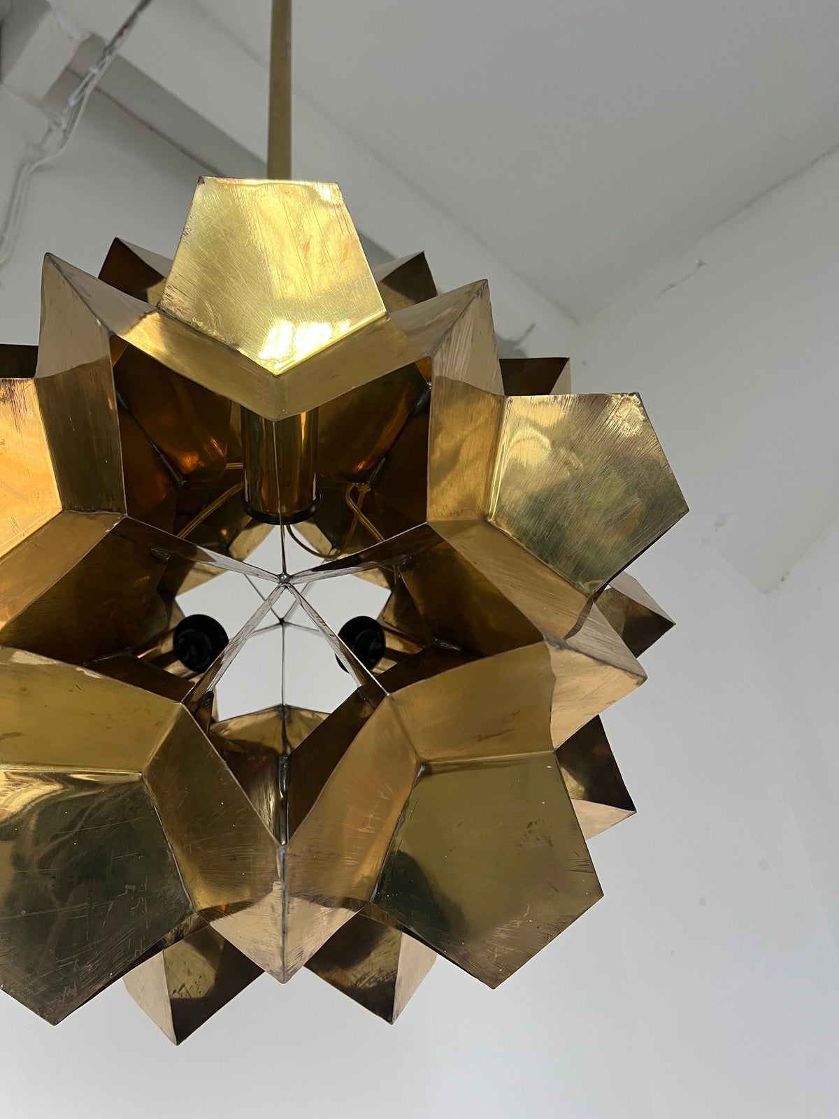The Brutalist Brass Chandelier by Veter Vintage, Latvia 70s, features a geometric gold-toned solid brass design with angular facets and hangs from the ceiling. Compatible with E27 bulbs, it's shown against a plain white background.