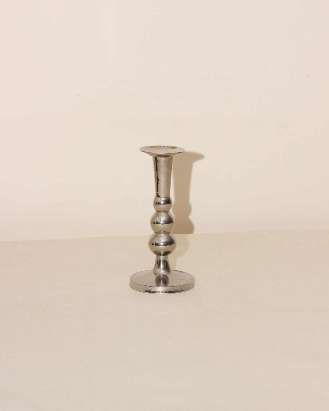 Polished steel candleholder with spherical stem detail view