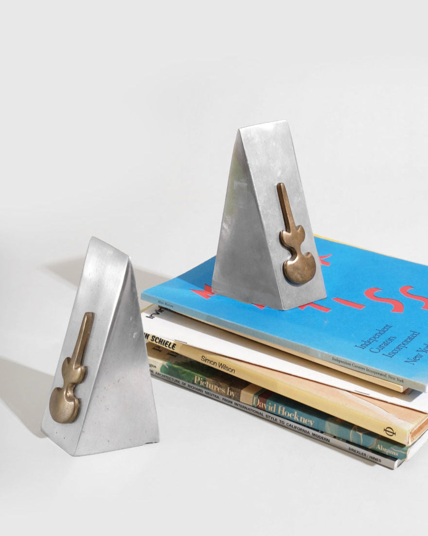 Modernist concrete bookend set with brass handles on stacked books