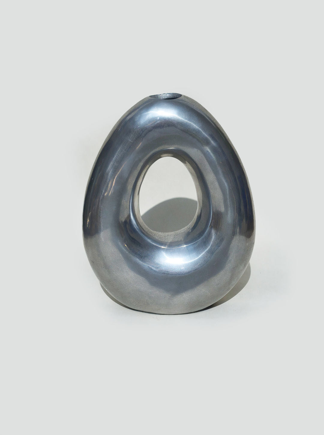 Smoky blue glass circular vase with central opening detail view