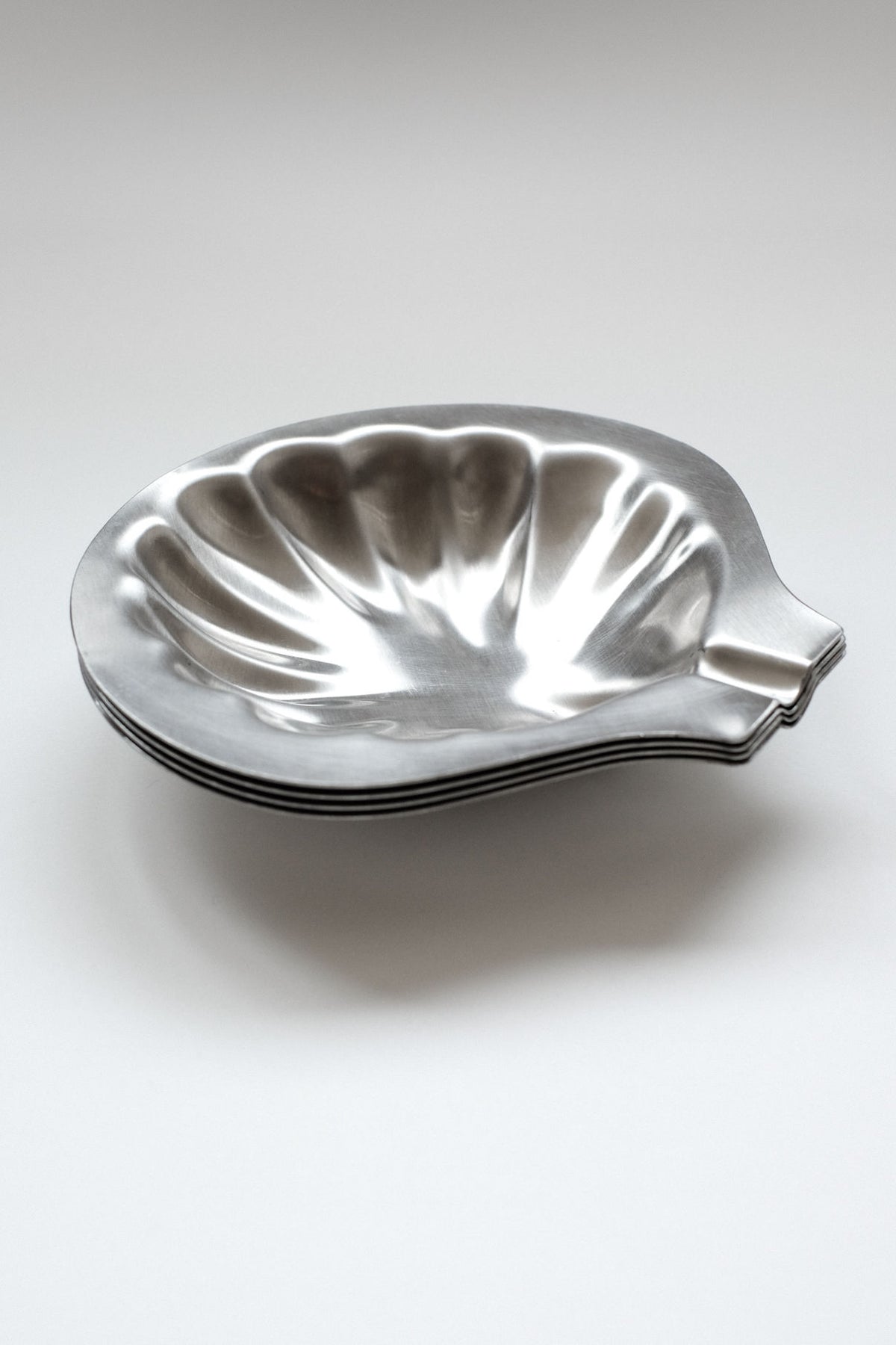 Polished silver shell-shaped decorative dish with scalloped edges