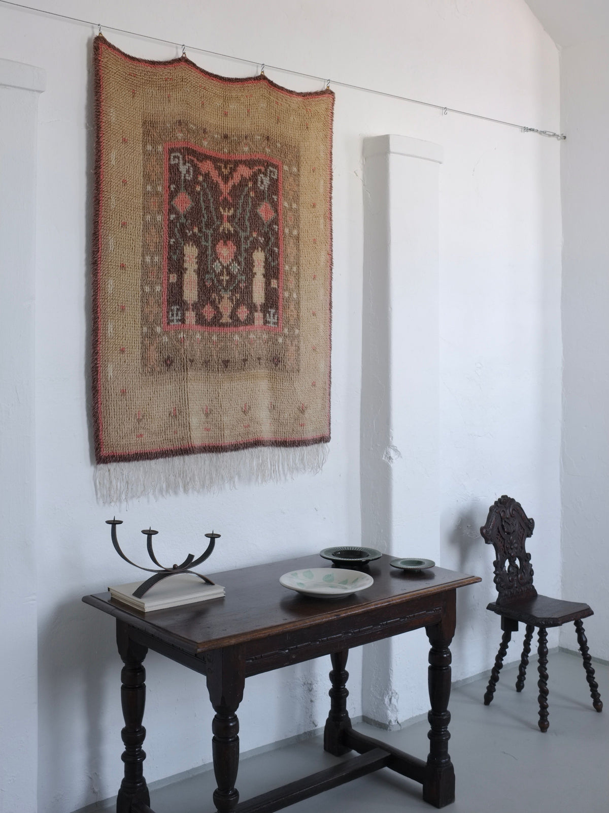 Hand-carved dark oak chair with ornate backrest in styled interior