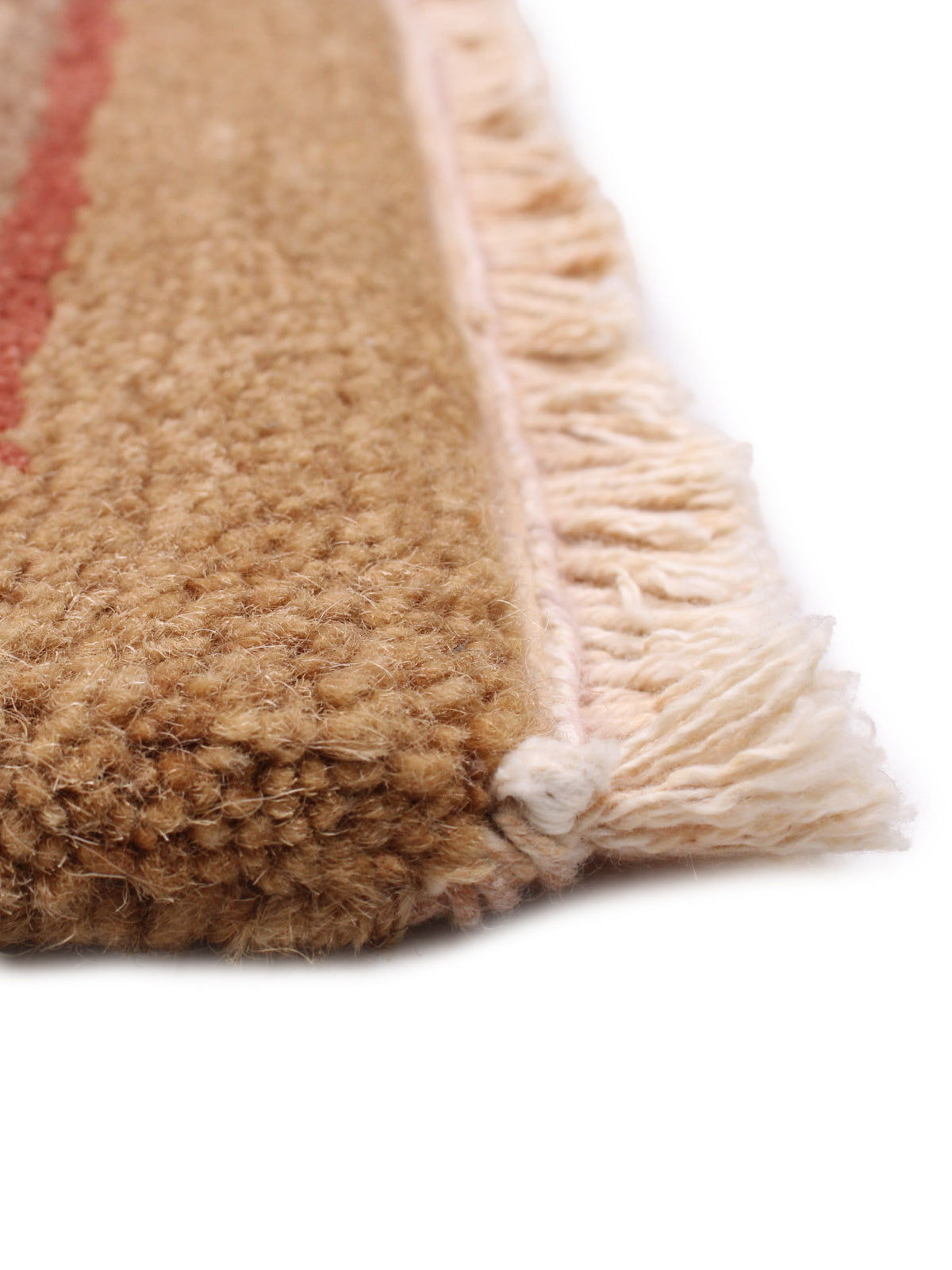 Close-up detail of Tibetan rug fringe and natural fiber texture