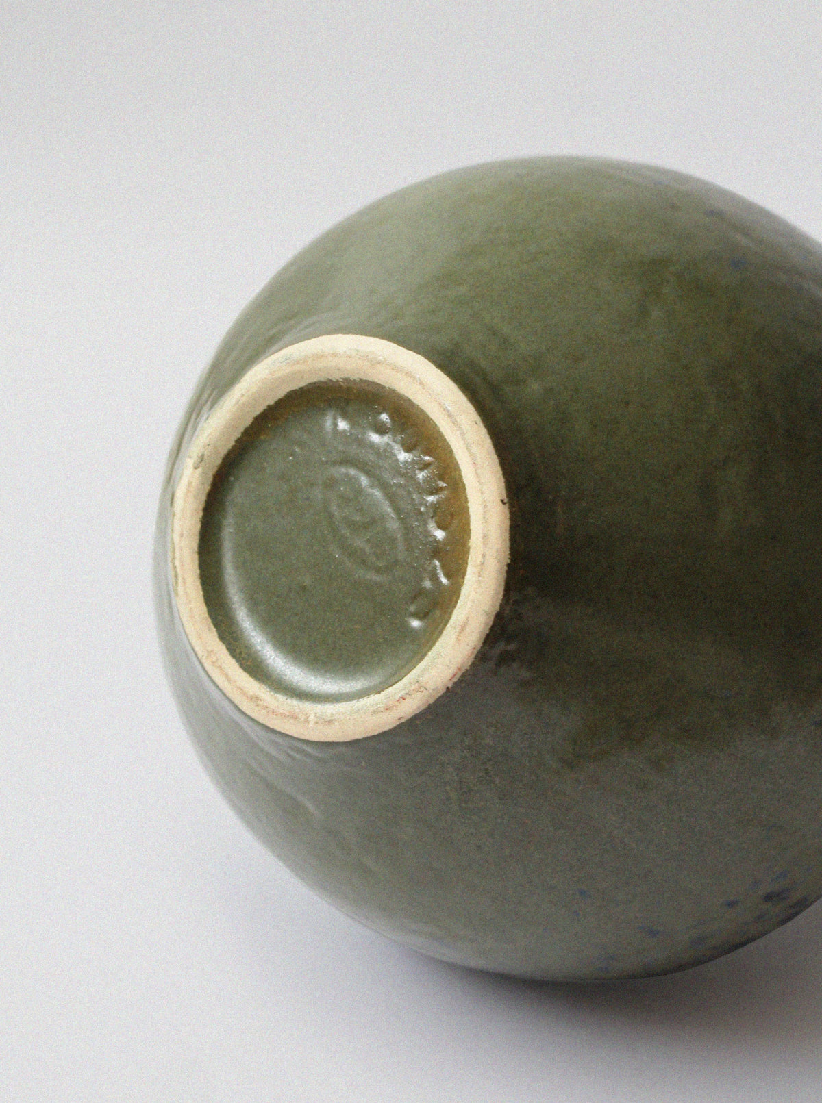Bottom view of 70s ceramic jug showing glazed olive green interior