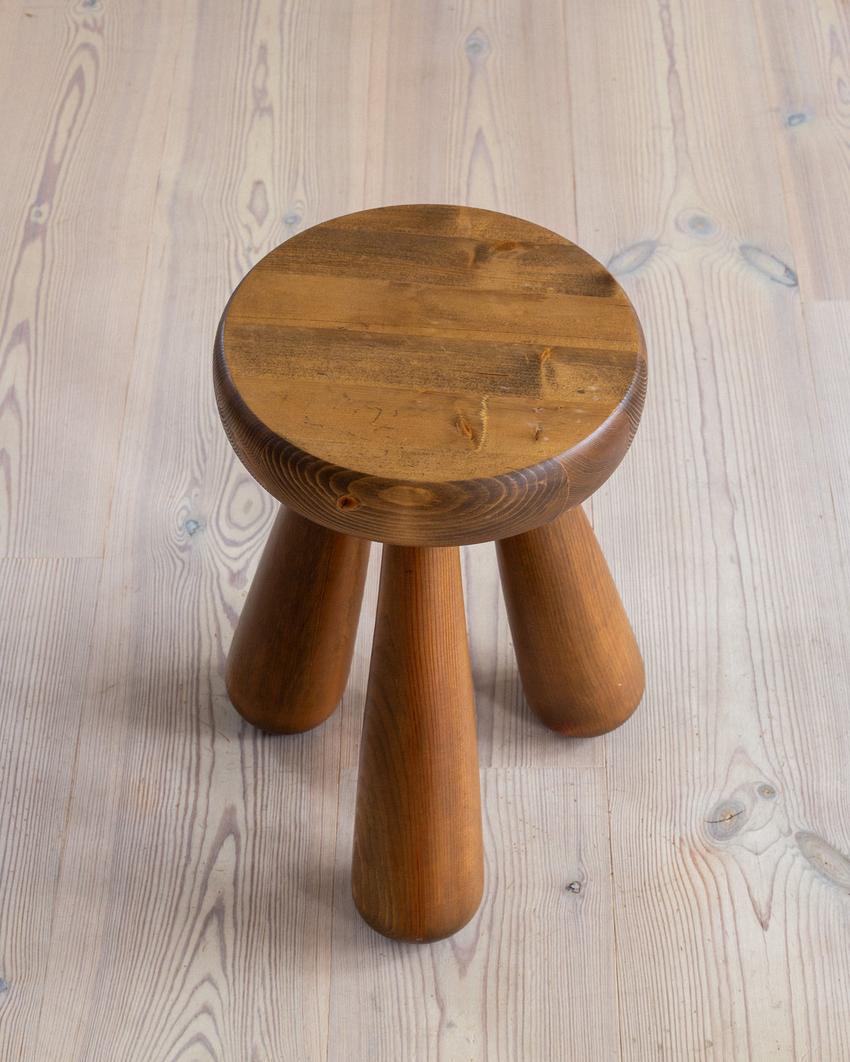 Vintage pine stool with round seat and cylindrical legs detail