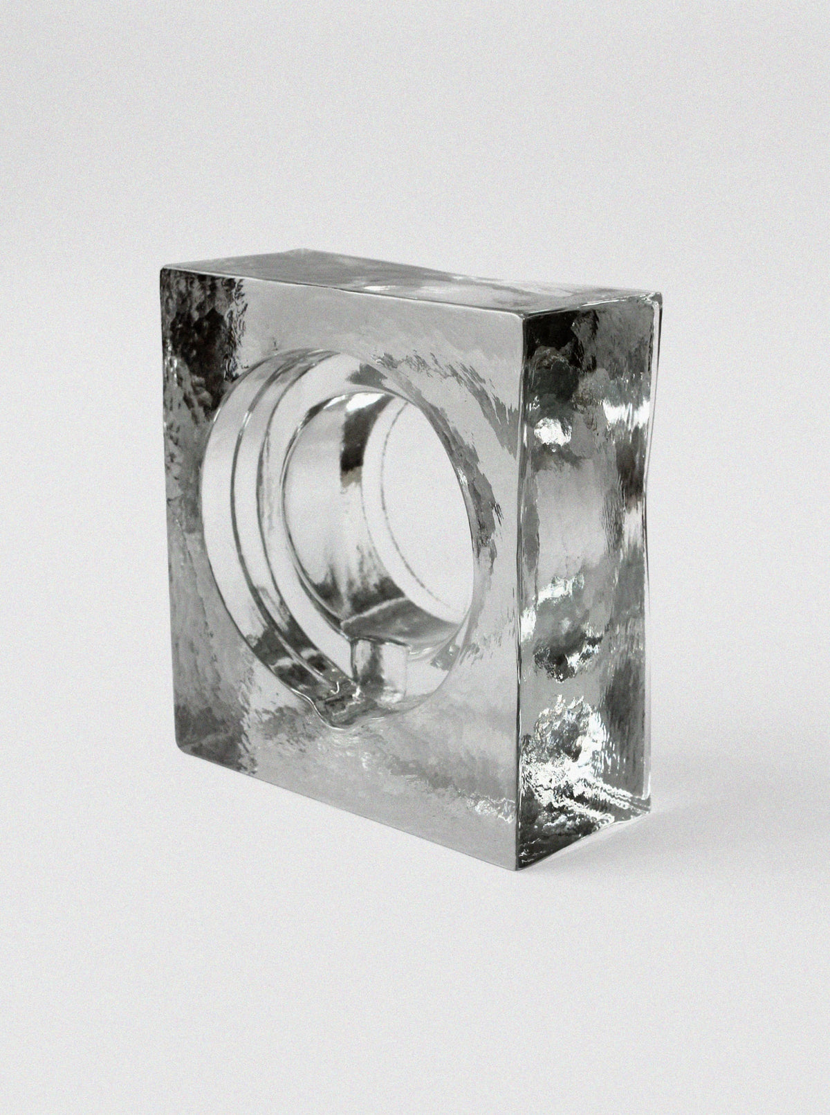 Massive ice glass ashtray showing sculptural hollow center detail