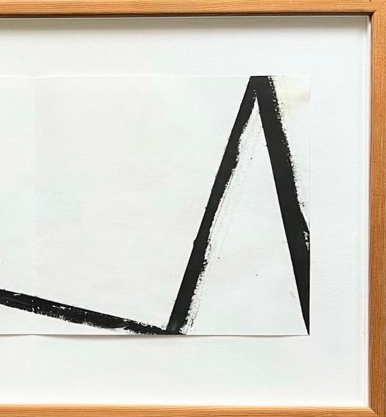This Richard Nonas Original Lithograph from Médecine features abstract artwork with bold black brushstrokes on a white background. It showcases a large angular shape resembling the letter 'A' within a wooden frame. This post-minimalist design pays homage to Richard Nonas, with textured paint edges that capture the depth of a lithograph.