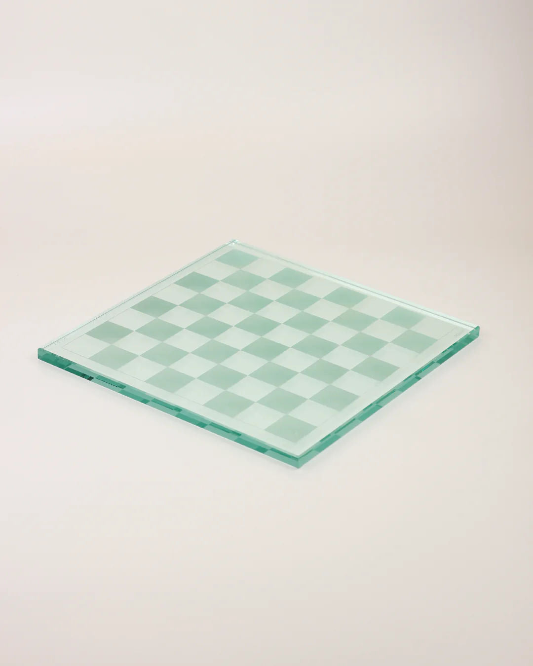 The Boga Avante Shop's Crystal Chess Set, with its clear and frosted squares on a simple light board, exemplifies minimalist design.