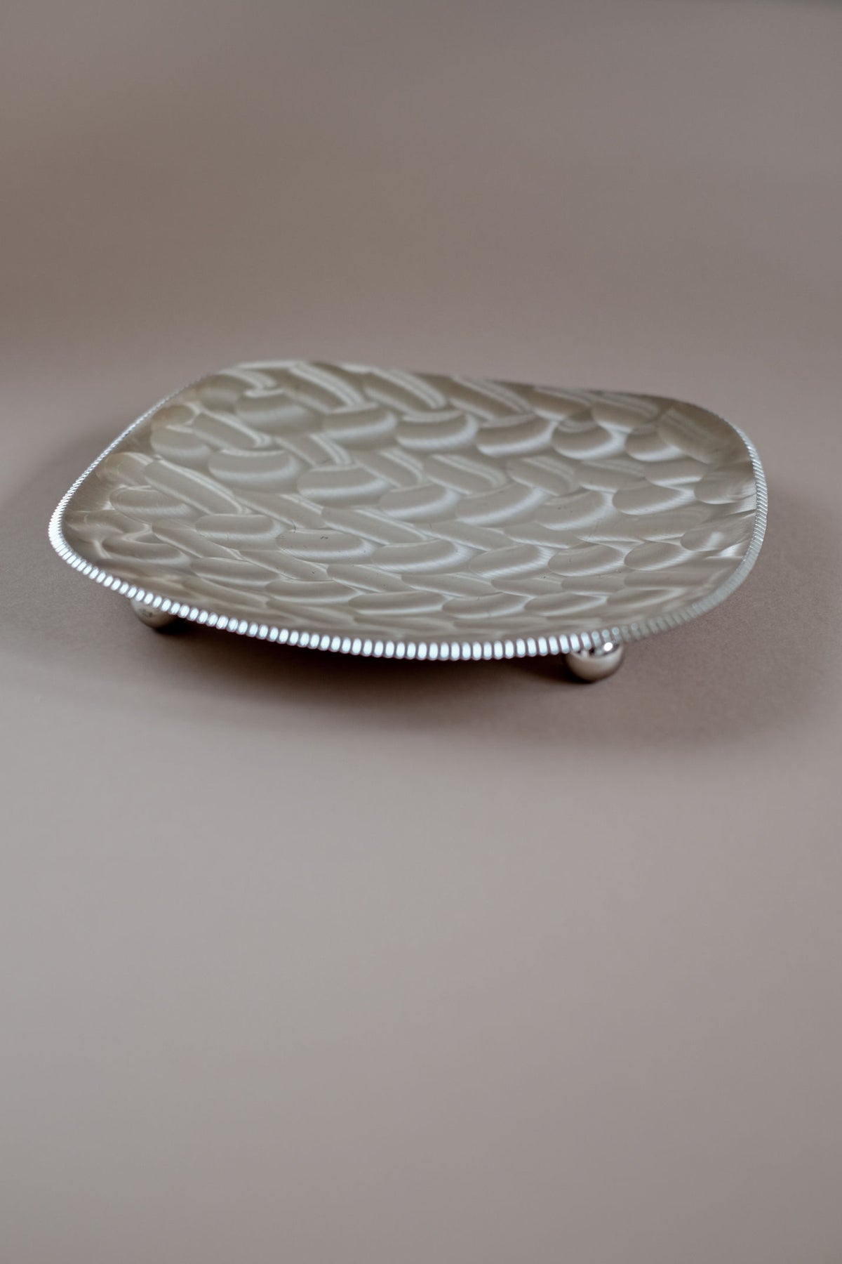 Silver-plated decorative dish with woven basketweave pattern detail