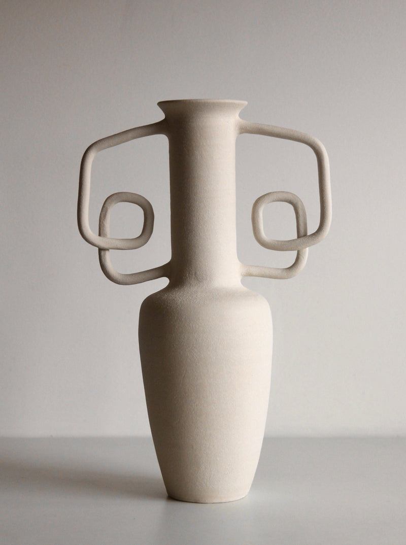 Handled Vessel - a sleek, modern ceramic vase with a curved handle