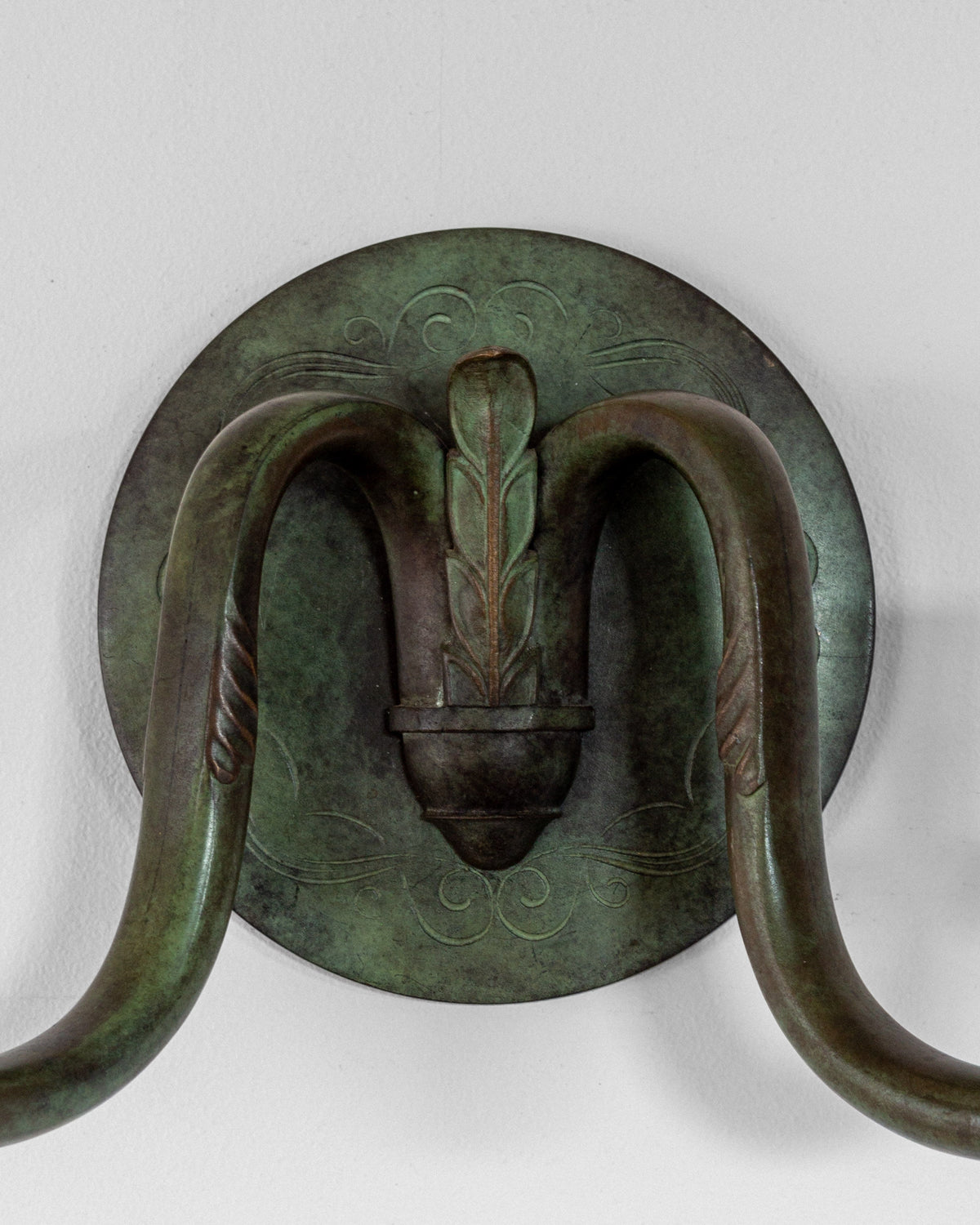 Art Deco bronze wall sconce with elephant trunk handles detail