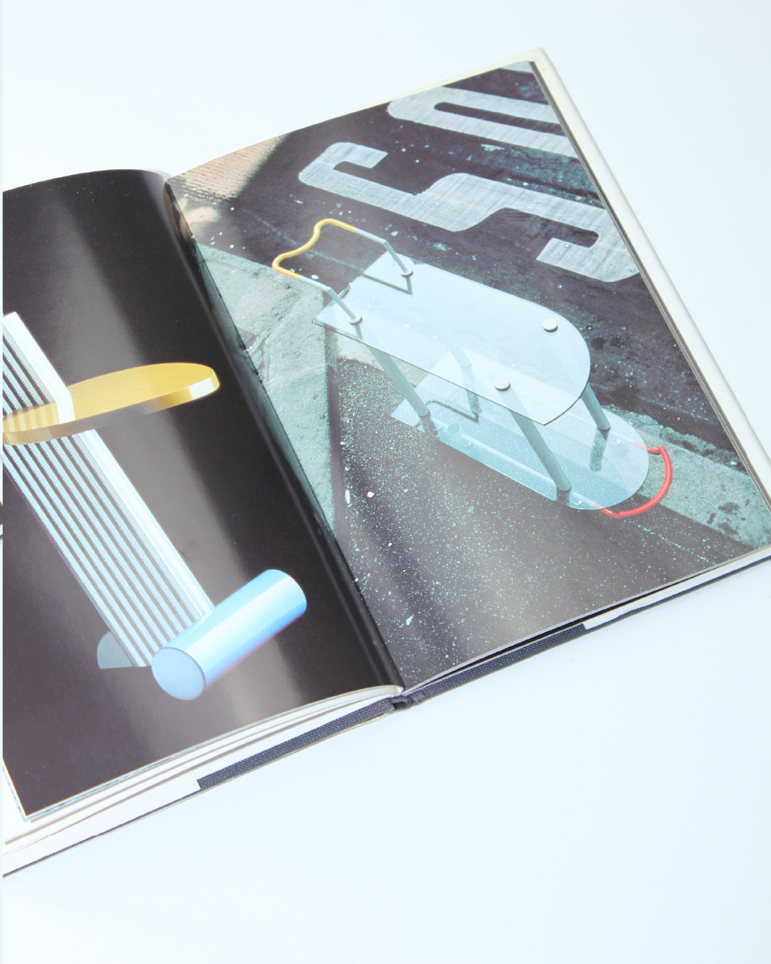 Open Memphis design book showing retro geometric objects and colorful illustrations