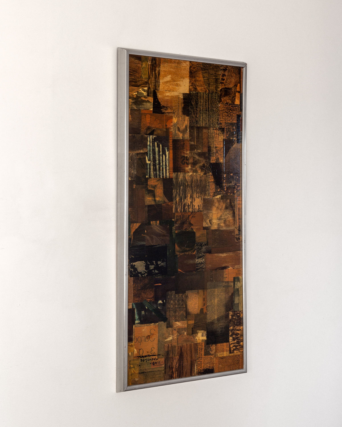 The Spigel Mid-Century Abstract Collage Artwork (1964, Sweden) features warm earthy tones of brown and orange with black accents. Enclosed in a simple silver frame, the piece showcases a textured pattern collage, embodying a mid-century modernist aesthetic on a plain white wall.