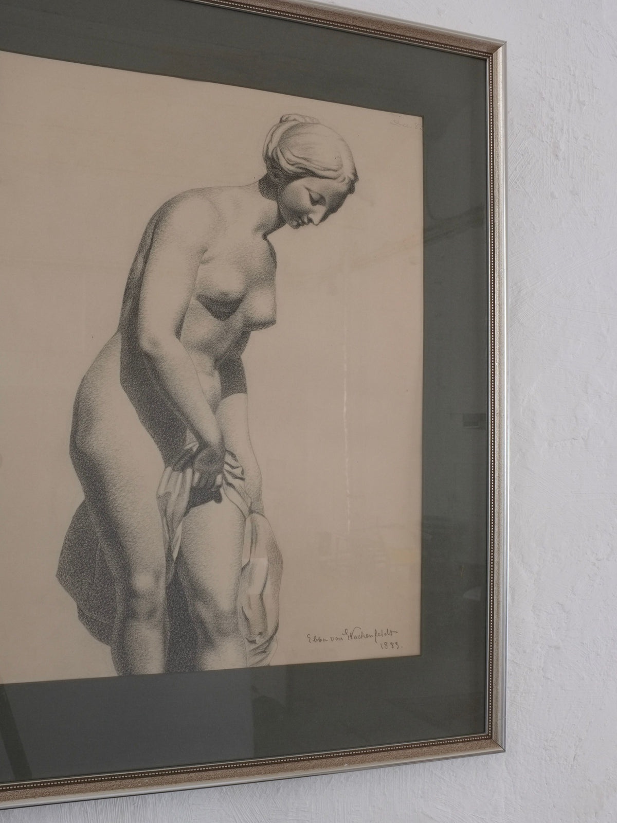 Ebba Von Wachenfeldt's 1883 charcoal drawing by Veter Vintage shows a nude woman looking down with a cloth in her right hand. A thin metallic frame complements this antique academic sketch, signed and dated 1933 in the bottom right corner.