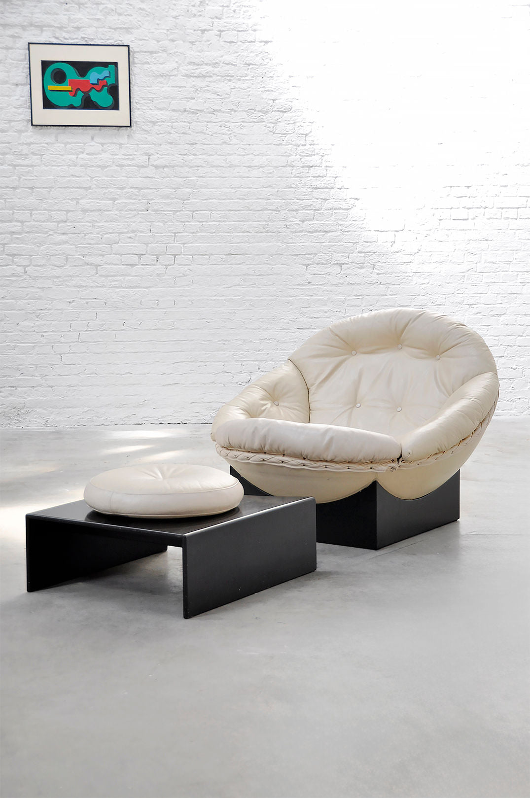 Cream leather Apollo lounge chair with ottoman on black bases