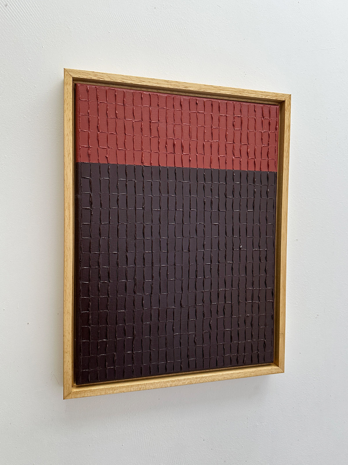 Textured red and brown abstract painting with geometric grid pattern