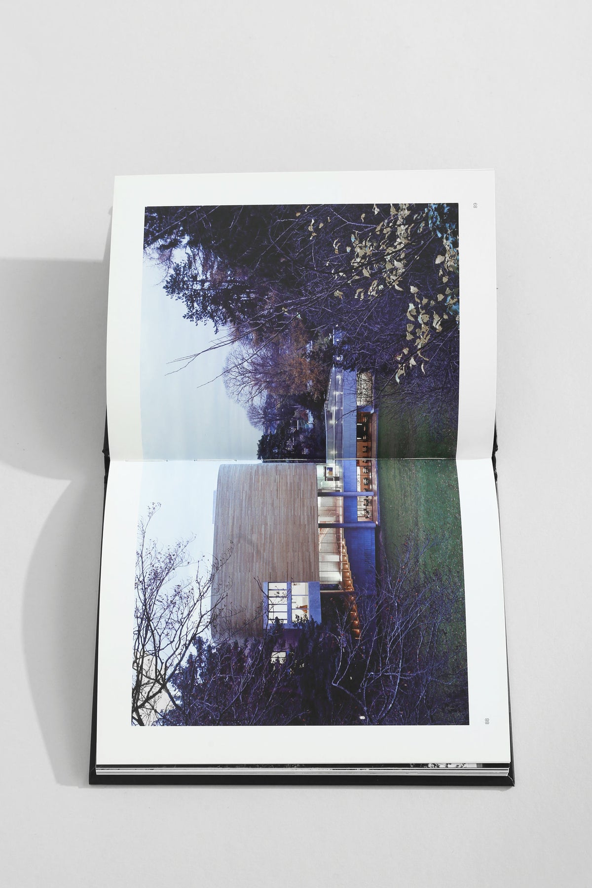 Modern architecture book open showing contemporary building exterior view