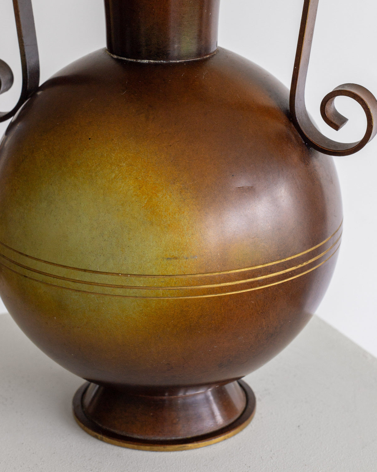Bronze Art Deco vase detail showing curved body and decorative bands