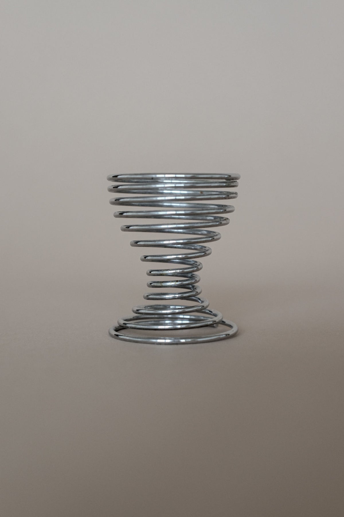 Metallic spiral egg cup detail showing coiled wire design