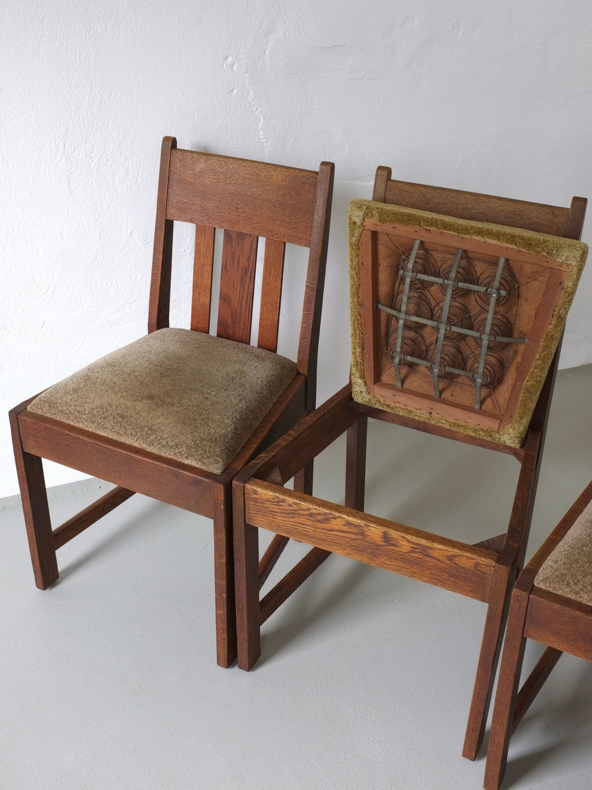 Underside detail of Arts & Crafts oak dining chair showing springs