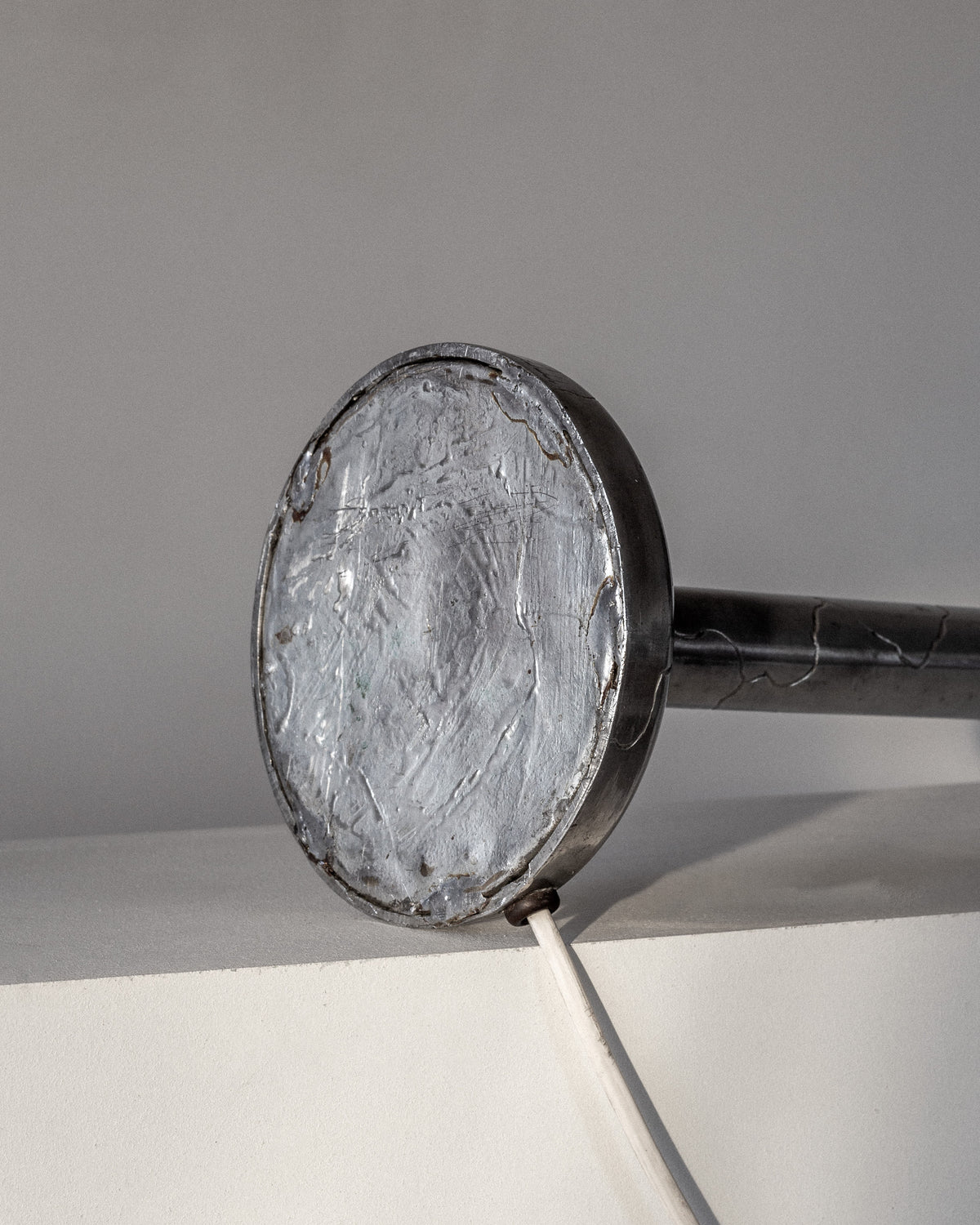 Close-up detail of pewter lamp base with textured metal finish