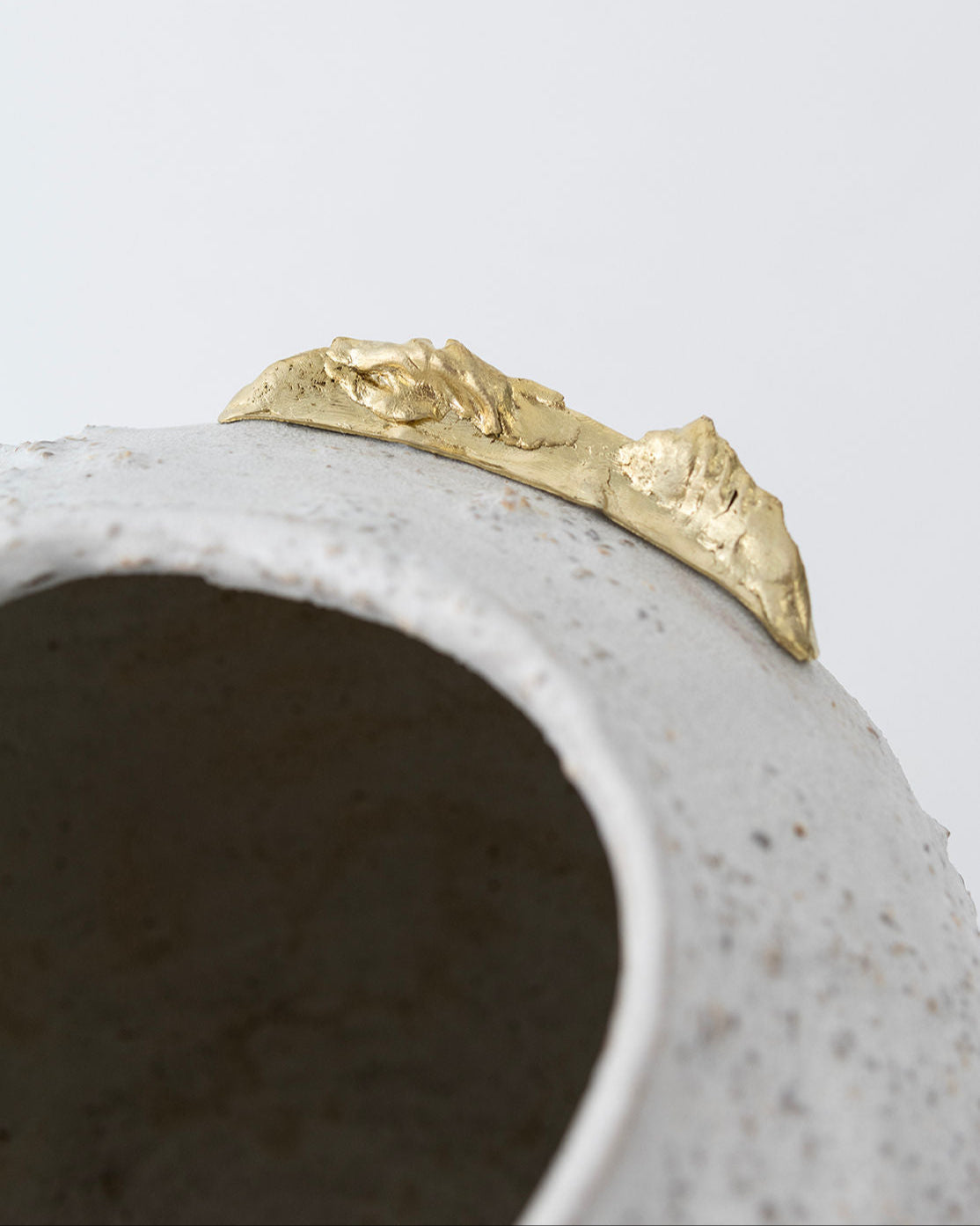 Golden sculptural detail on rim of Isolated n.10 Blanco Hueso vase