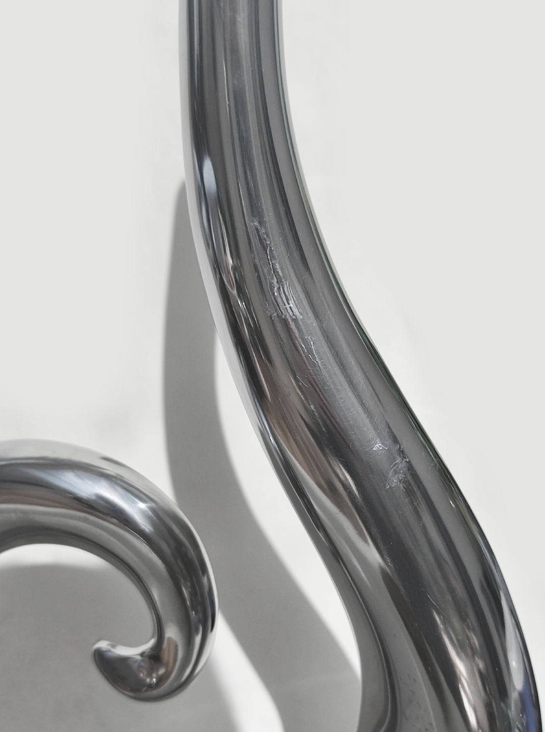 Curved glass detail of transparent spiral vase showing fluid form