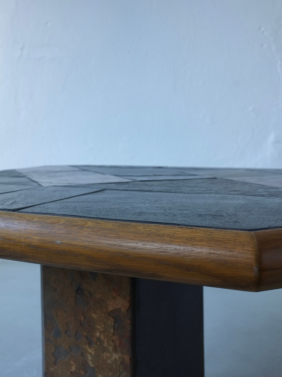 Close-up detail of brutalist stone and oak coffee table edge