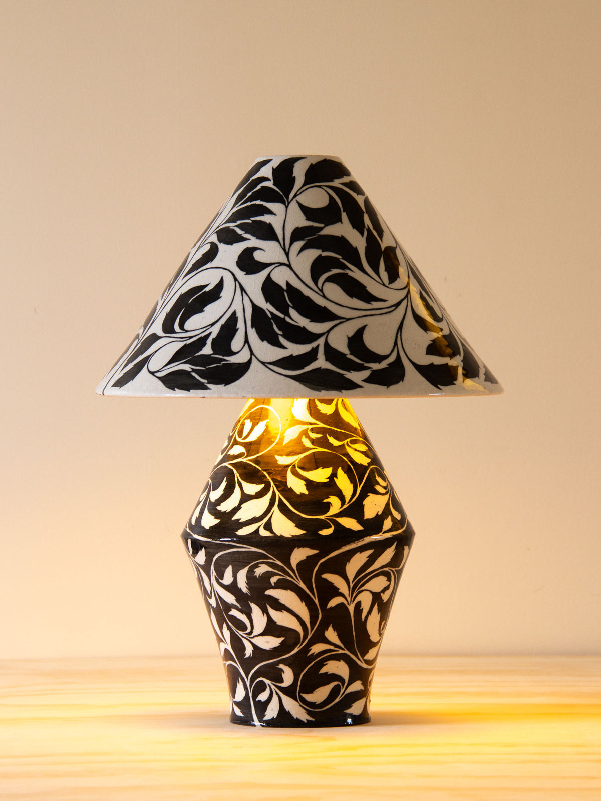 Illuminated paisley table lamp showing decorative pattern detail