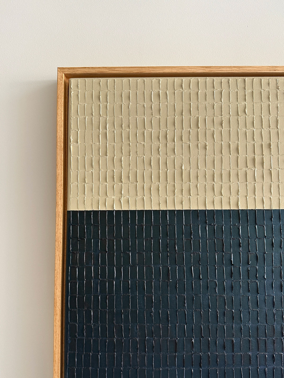 Textured painting detail showing cream and navy blue sections