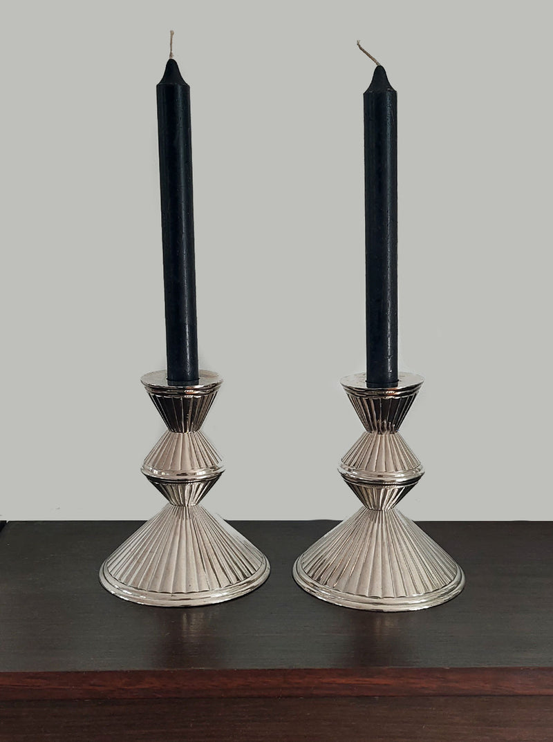 Handcrafted metal candle holders featuring intricate floral designs in a set of 2