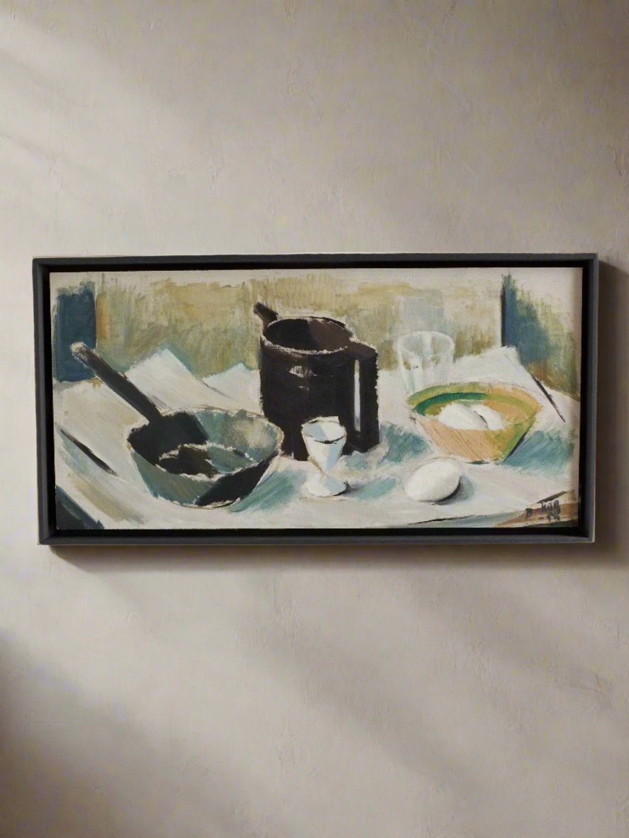 The Vintage Still Life Oil Painting "Breakfast" by Veter Vintage from the 1960s in Sweden features a framed depiction of a classic still life arrangement, showcasing a black pot, a black ladle, a cup, a green bowl, a white egg, and a glass placed on a blue and white cloth. The color palette consists of muted tones with an emphasis on the contrast between light and dark.