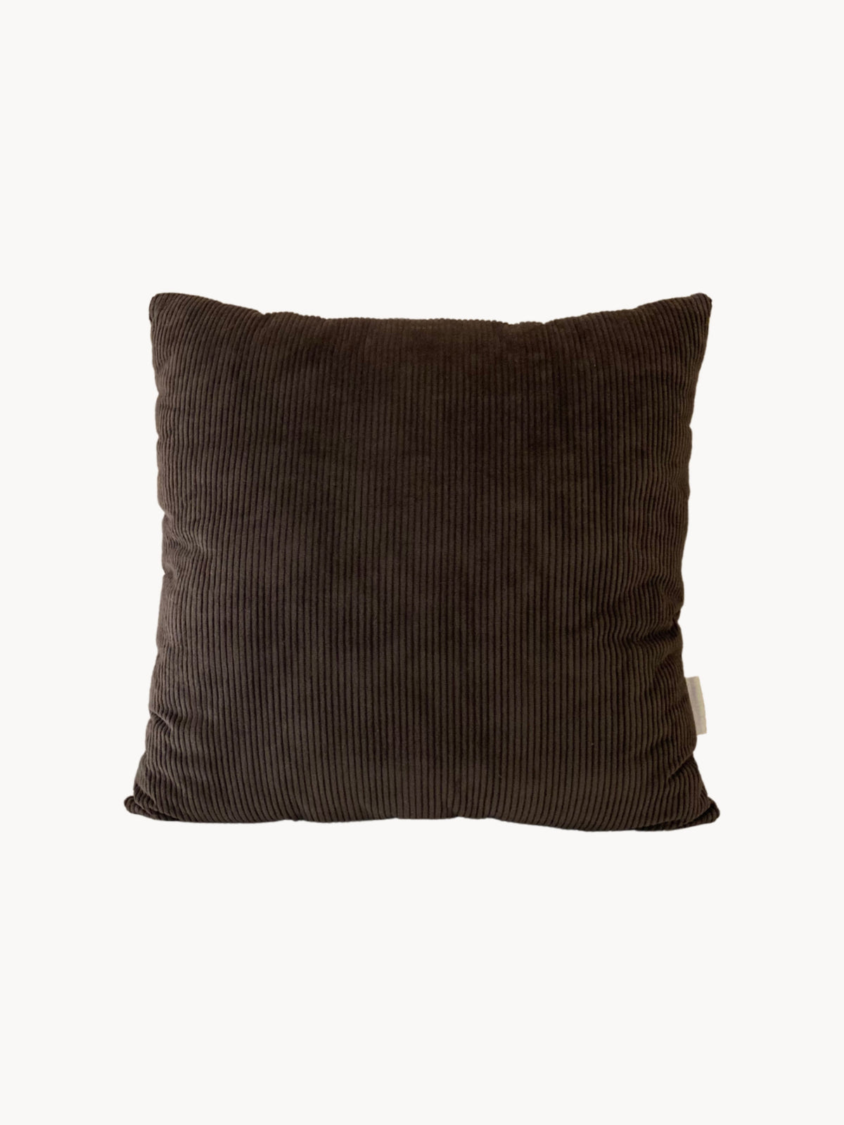 A square, brown corduroy cushion with subtle vertical ridges. This Handmade UK cushion appears plush and soft, complete with a tag on the side. The background is plain white.

Replaced: A square, brown corduroy cushion with subtle vertical ridges. This Le Carré - Cotton Corduroy - Chalk/Espresso by AMÉLIORÉ appears plush and soft, complete with a tag on the side. The background is plain white.