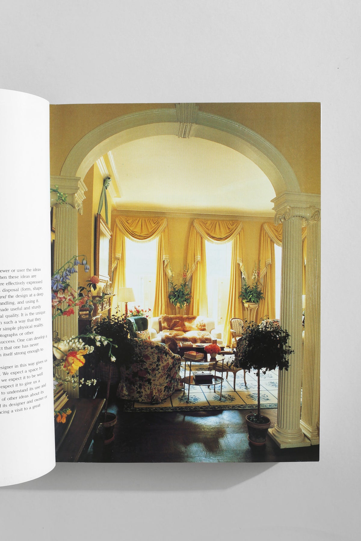 Classical living room with columns and yellow drapery from interior design book