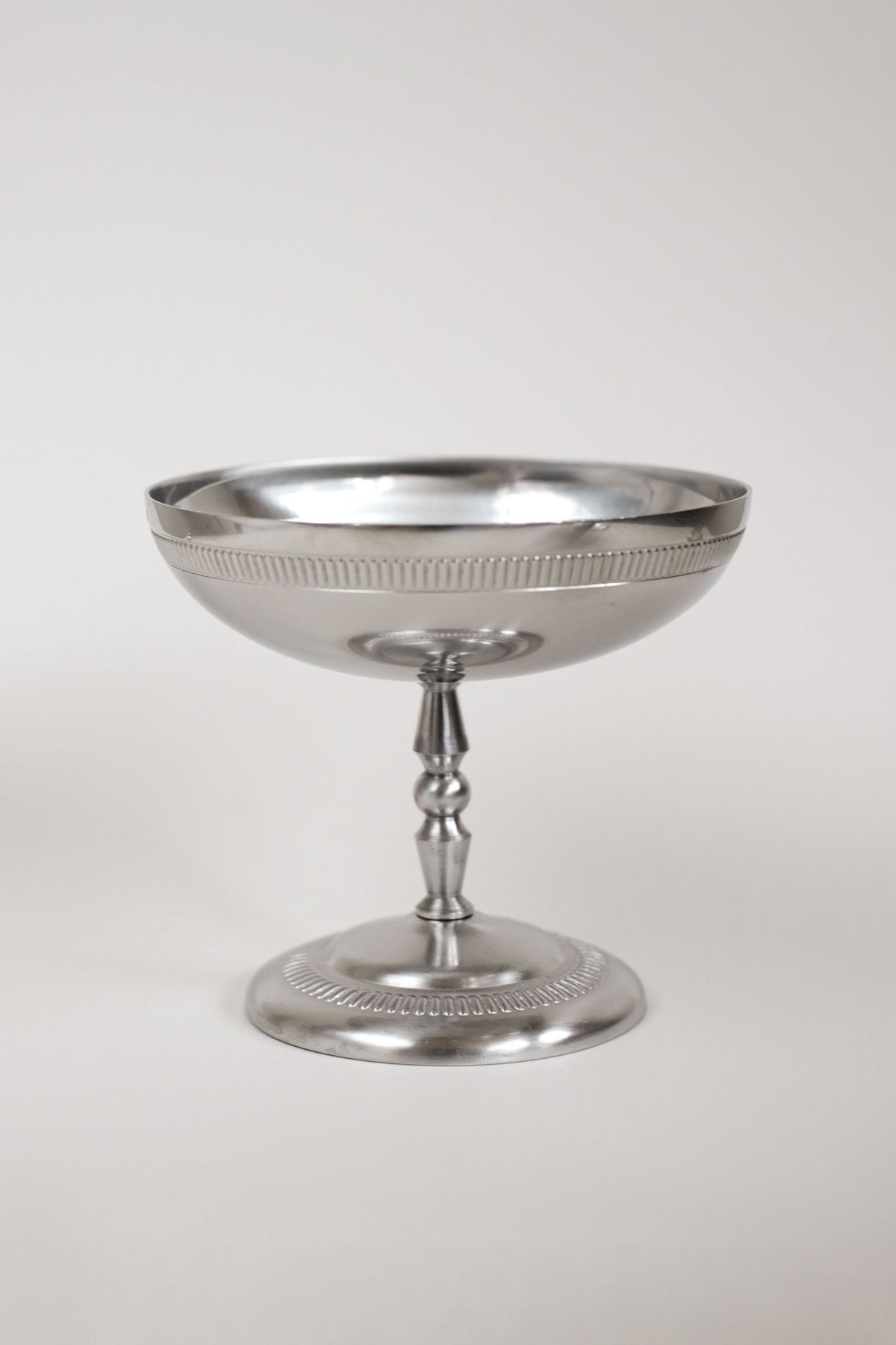 Polished silver compote bowl on pedestal stem with decorative rim