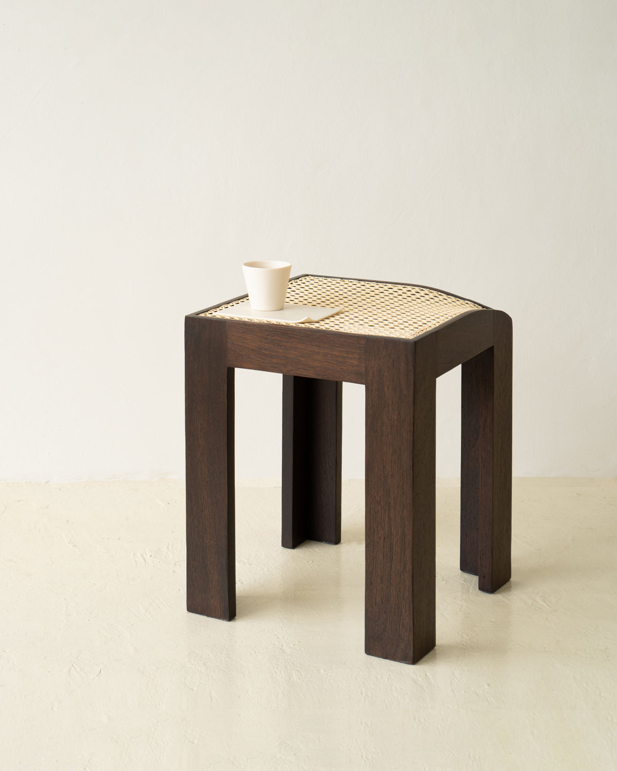 Canto walnut stool with woven cane seat by Andre Grippi