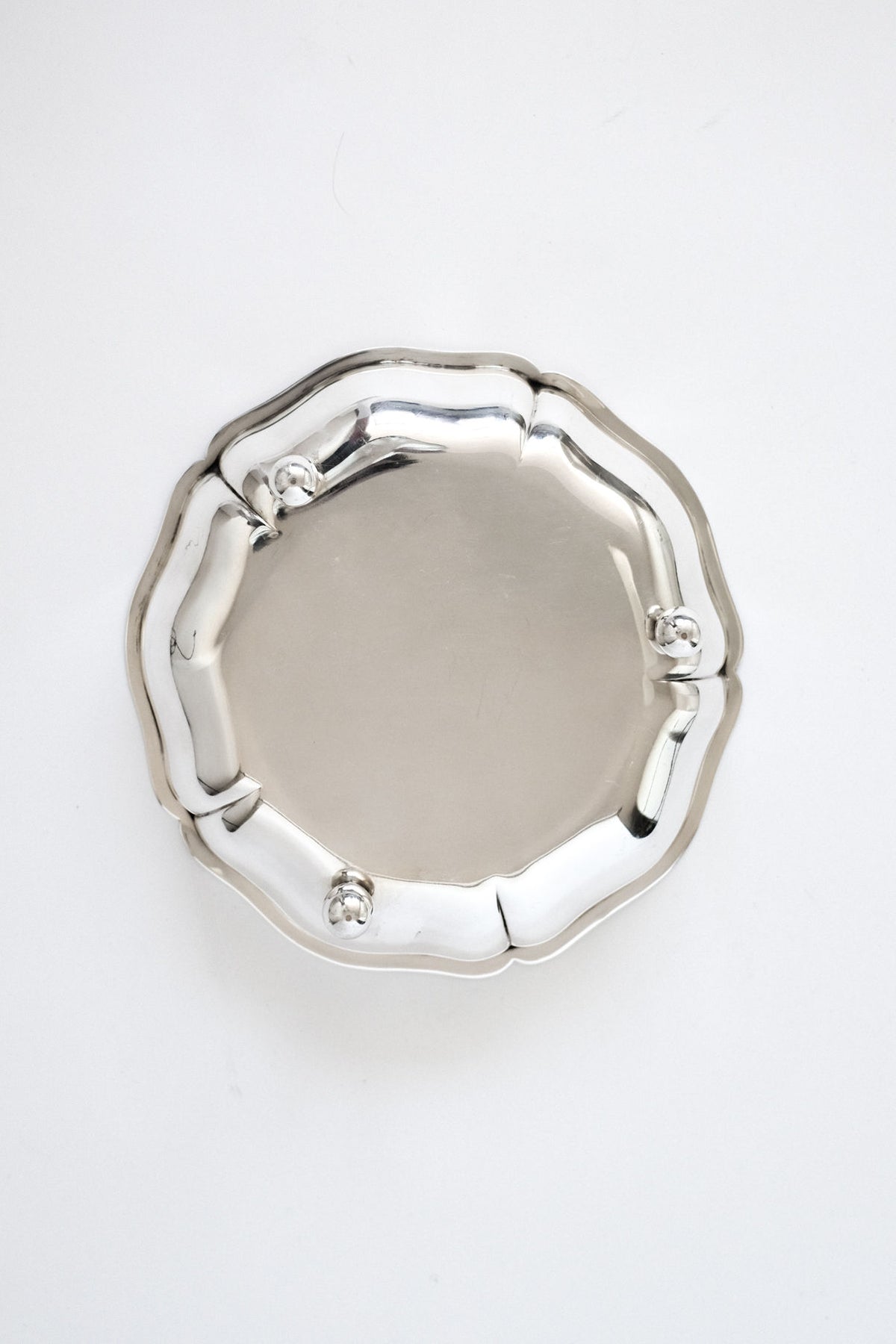 The septembre studios Silver-plated Bowl features a round shape, scalloped edge, and three raised decorative knobs, shown against a plain white background.