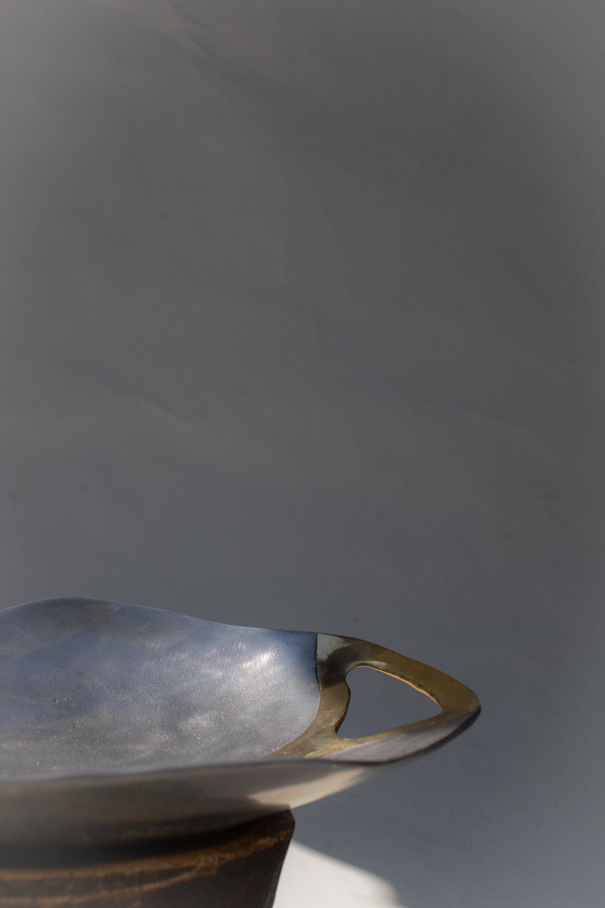 Brutalist bowl side profile showing sculptural handle detail