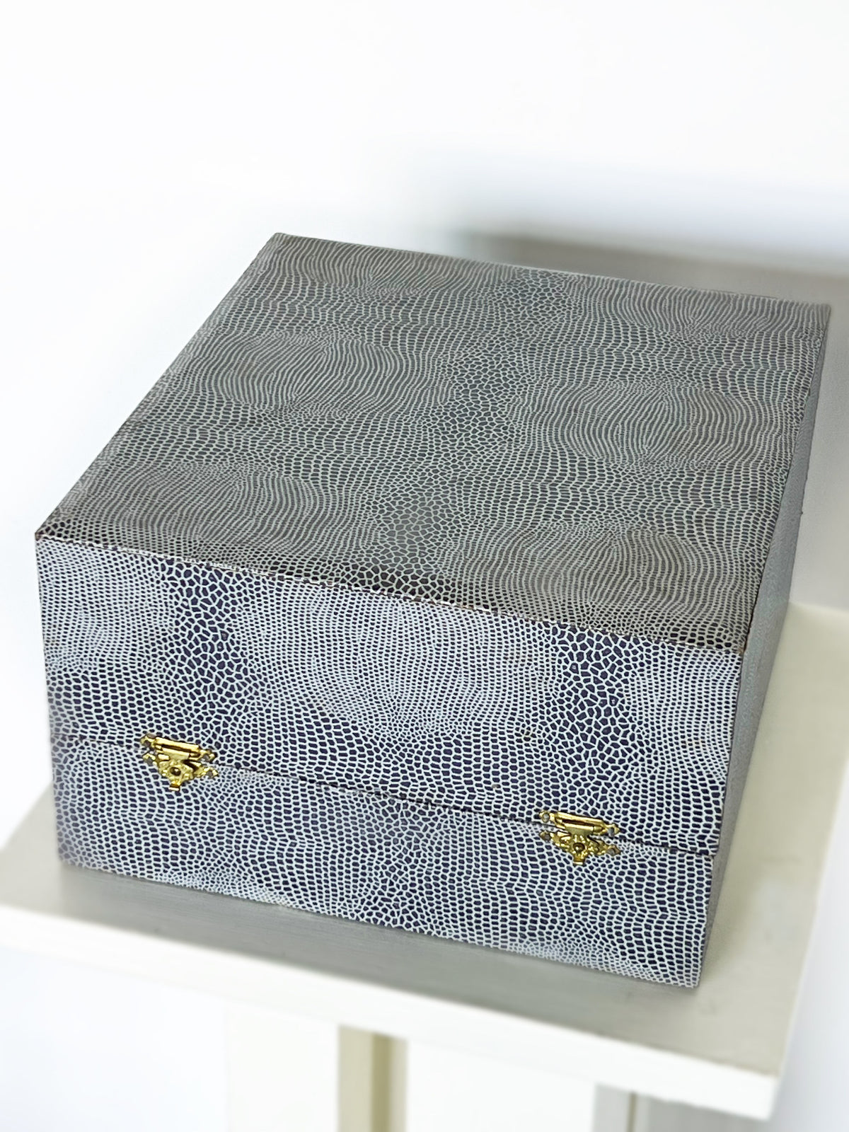 Black and white geometric patterned ice bucket with brass handles detail