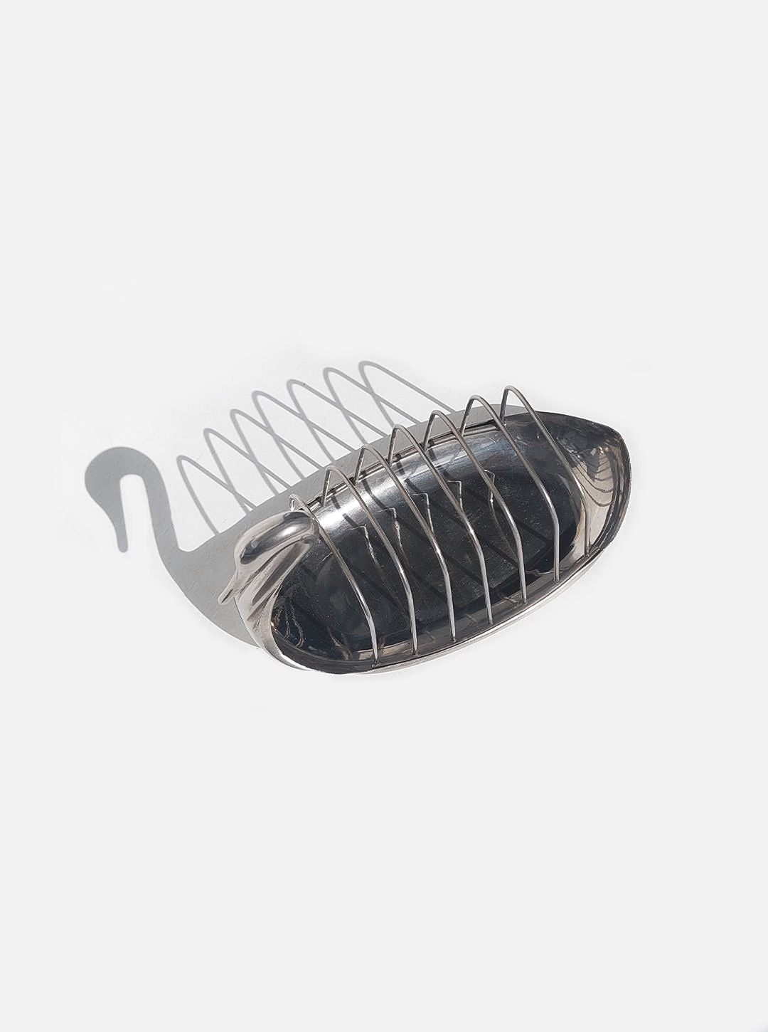 A brass Swan Toast Rack soap holder with a curved, open wire design set against a plain white background by Les Objoies.