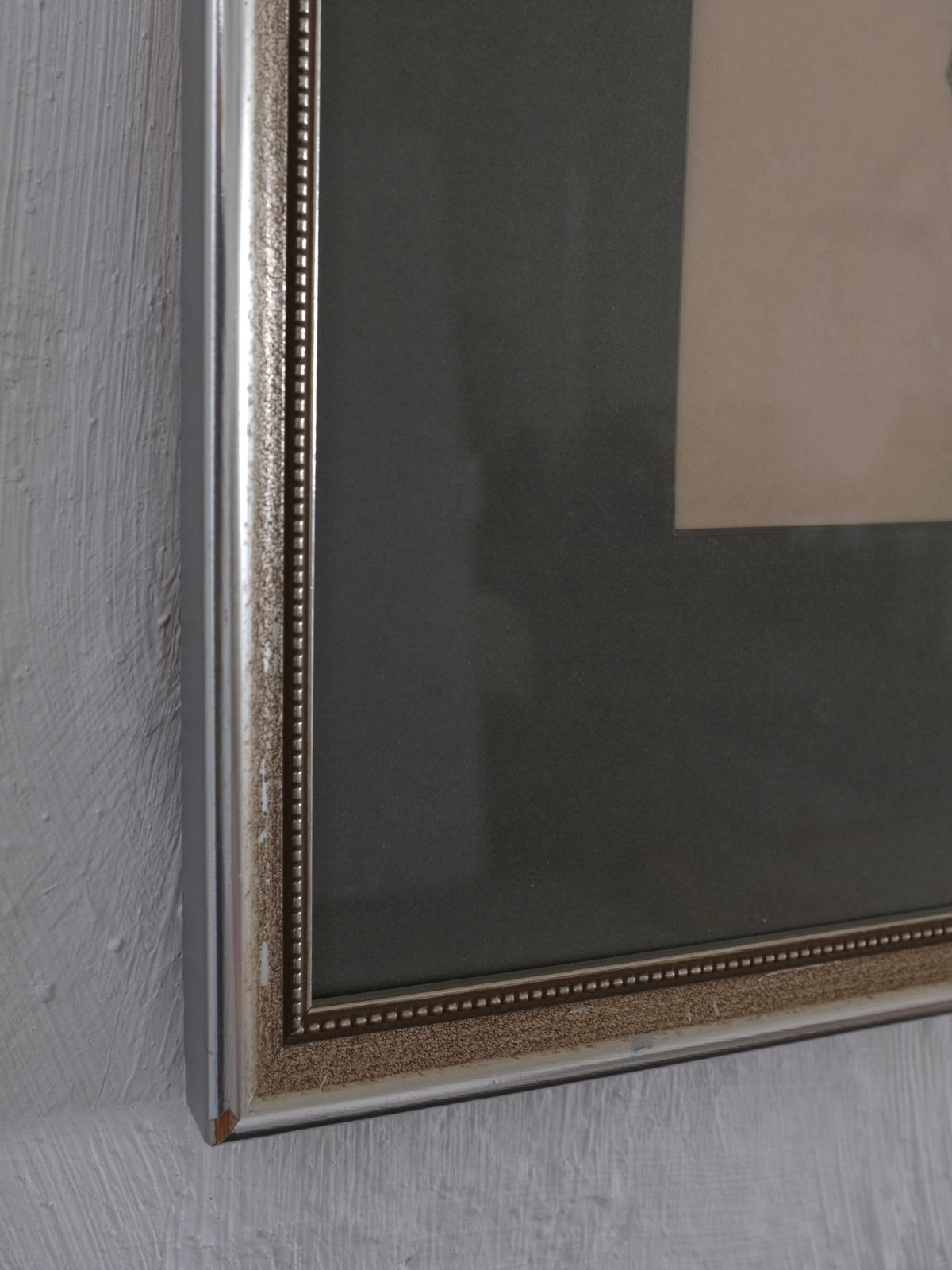 Close-up of a framed Veter Vintage artwork on a textured wall. The metallic frame shows wear at the corner, displaying an antique academic charcoal drawing, "Ebba Von Wachenfeldt Charcoal Drawing 1883," with a dark mat surrounding the visible part.