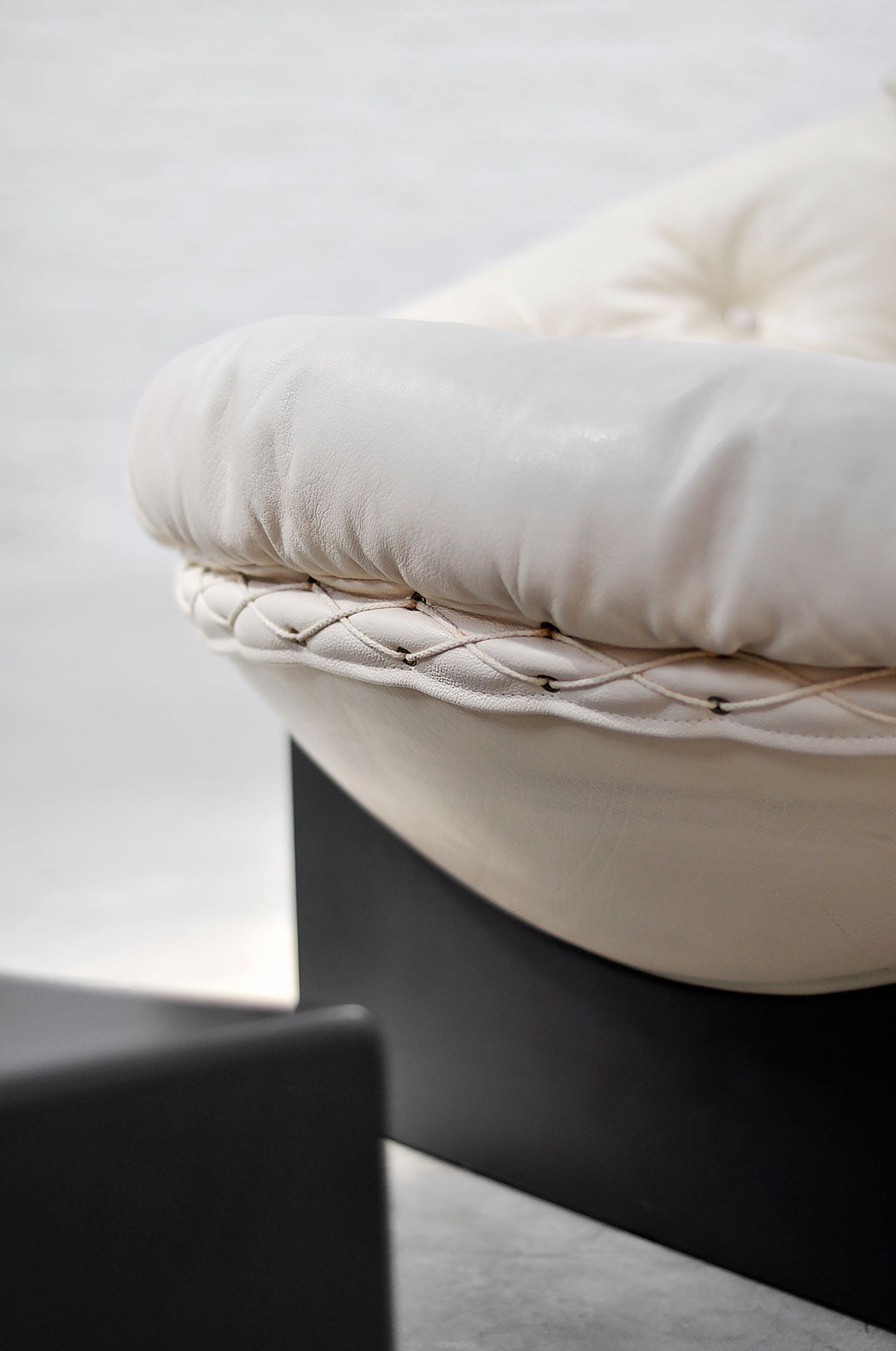 Cream upholstered seat cushion detail of Apollo lounge chair