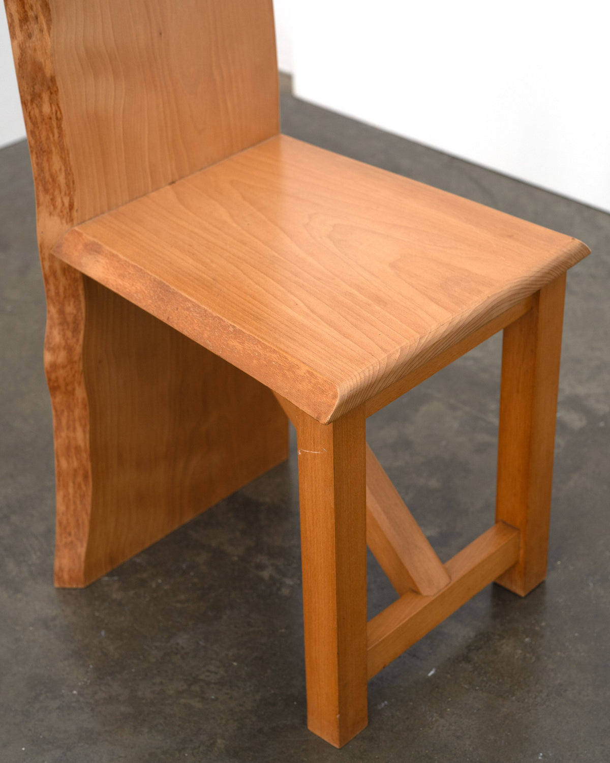 Natural oak live edge chair showing grain detail and cantilever base