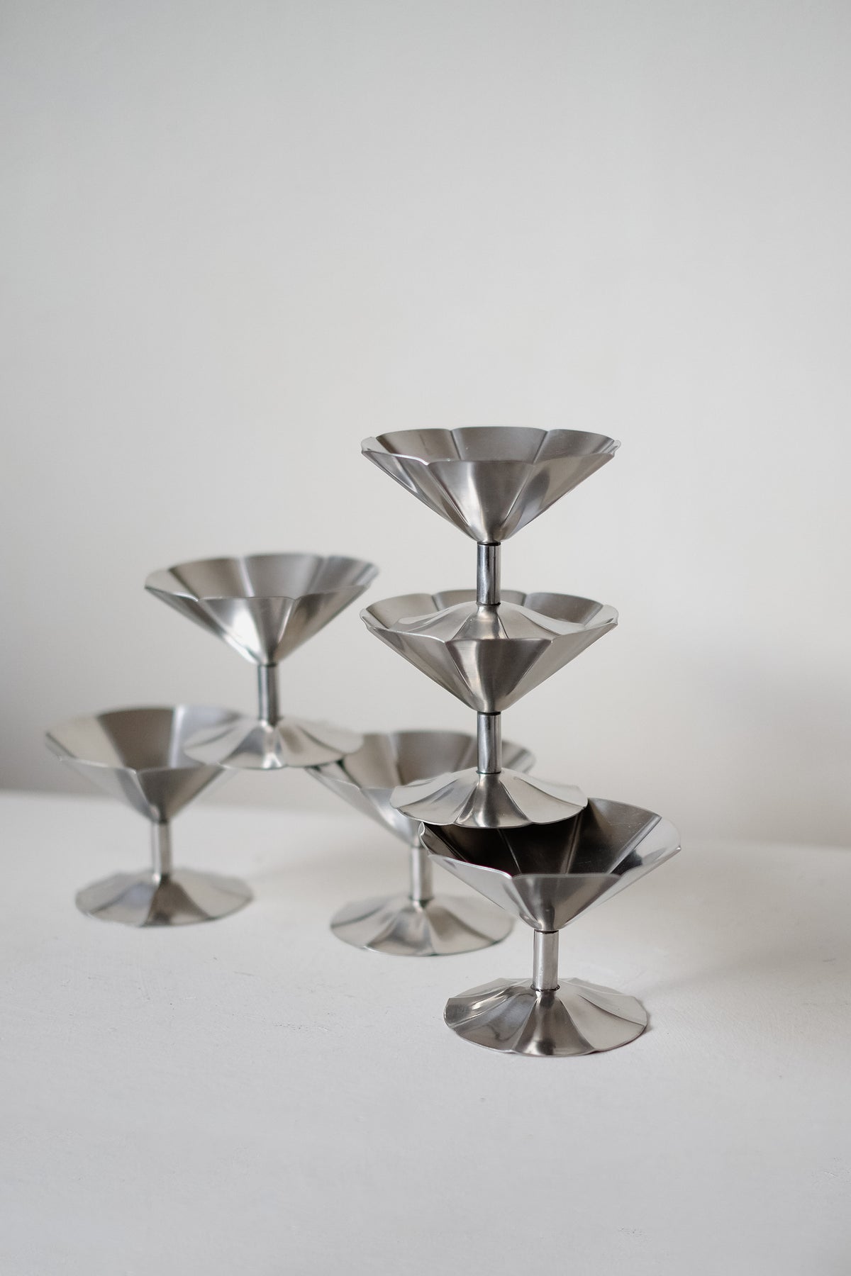 The Set of 6 Ice Coupes by septembre studios stands elegantly in a triangular formation on a white surface against a plain background.